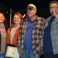 Keith and Darlene Bass accept an award from Debi and Ernie Evans at the 2019 Yee Haw Music Fest - photo © Bill Warren