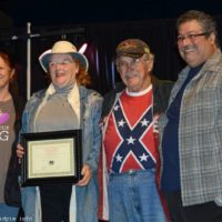 Pete and Edythe Petrick accept the Customer Care award from Debi and Ernie Evans at the 2019 Yee Haw Music Fest - photo © Bill Warren