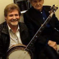 Christopher Harnett brings the eagle banjo for Ralph to see at his 85th birthday celebration