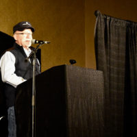 Gene Milligan speaks during the CBMS Hall of Honor at the 2019 MidWinter Bluegrass Festival