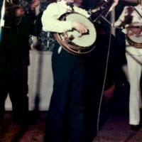 Christopher Harnett at 8 years old playing the eagle banjo his father bought for him