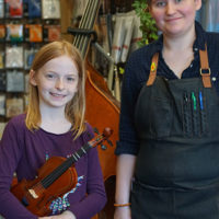 Cat Autrey with a young fiddler at Tulsa Strings - photo by Pamm Tucker