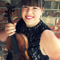 Amy Lavicky with her fiddle that had been in WWII