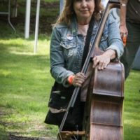 Missy Raines schleps her bass at the Spring 2019 Gettysburg Bluegrass Festival - photo by Frank Baker
