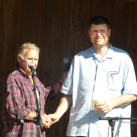 Herb Key presents second place winner, Ben Cockman of Sherrills Ford, NC, with his plaque and prize money at the 2019 Wayne Henderson Festival - photo by Sandy Hatley