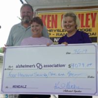 The Hickmans present a check to the Alzheimer’s Association representative Pam Myers at the 2019 Norwalk Music Festival - photo © Bill Warren