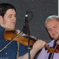 Adam Burrows and Stanley Efaw twin fiddle at the 2019 Marshall Bluegrass Festival - photo © Bill Warren
