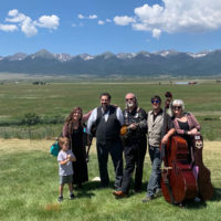 Savage Hearts with the Rocky Mountains behind them at the 2019 High Mountain Hay Fever Festival in Colorado