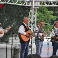 Caney Creek is singin' in the rain at the 2019 Remington Ryde Bluegrass Festival - photo by Frank Baker
