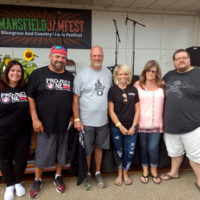 Chris and Missy Smith with representatives of the  Project One Recovery Road organization, and Tanya Morrow from Ploger Transportation at the 2019 Mansfield Jamfest