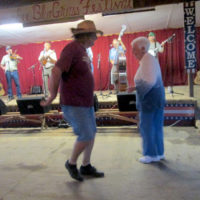 Chuck Headden and 93 year old Ann Gonzales, two longtime supporters and attendees of the festival, kick up their heels to a Bluegrass Fever tune at the 2019 Armuchee Bluegrass Festival - photo by Audie Finnell
