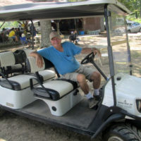 Gary Kastee in his "stretch" golf cart. Gary is a longtime festival volunteer who coordinates the RV camping sites, starting on the preceding Monday, when the early birds start arriving at the 2019 Armuchee Bluegrass Festival - photo by Audie Finnell