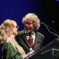 Alice Gerrard and Sam Bush present at the 2019 IBMA Awards Show - photo by Frank Baker