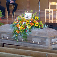 Brown Loflin lies in state at the foot of the stage during his funeral at Denton Farm Park (9/16/19) - photo by Gary Hatley