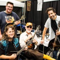 Tara Linhardt, Ryan Paisley, Doyle Lawson at a mandolin gathering in the exhibit hall at World of Bluegrass 2019 - photo © Tara Linhardt