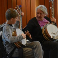 Two students at The 2019 Banjo Summit interact during a lesson - photo by Kevin Slick