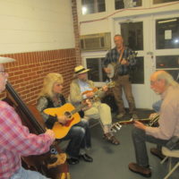 Donald Goode (banjo) and his band getting in a little practice in the foyer before going on at the Snow Hill Bluegrass Jamboree - photo by Audie Finnell