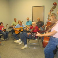 Ninety-one year old area fiddling icon, Hayes Dixon, leading a jam in one of the many classrooms at the Snow Hill Bluegrass Jamboree - photo by Audie Finnell