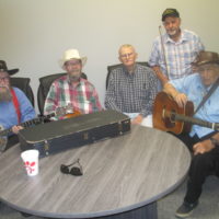 Old Tyme and Country jammers in one of the smaller classrooms. Curtis Hicks (banjo) and Ernie Barton (guitar) are regular show openers, entertaining with their own special blend of old time and country favorites at the Snow Hill Bluegrass Jamboree - photo by Audie Finnell