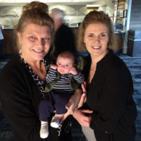 Lisa Efaw and Becky Wilcox hold Chris Smith's grandson, Karter, at the 2020 Bluegrass in Superclass - photo by Chris Smith