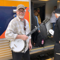 Ted Kuster greets travelers on the Amtrak to the Great 48 Jam - photo by Dave Berry