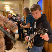 Tuning break during a hallway jam at Wintergrass 2020 - photo by Mary Ann Goldstein