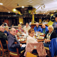 Lorraine Jordan entertains dinner guests on Danny Stewart's West Coast Bluegrass Cruise