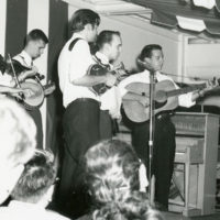 The Lonesome River Boys  Buck Buchannan (fiddle), Rick Churchill (banjo), Jack Tottle (mandolin), Dick Stowe (bass)[singing], John Kaparakis (guitar) aboard the cruise ship, S. S. Mt. Vernon, early 1960s