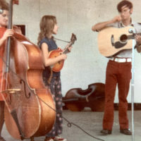 Young Rhonda Vincent playing her first mandolin, an A-2 Gibson Florentine, with Sally Mountain Show. Also pictured are Carolyn Vincent on bass and Kirk Brandenberger on guitar.