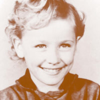 Dolly Parton wearing her “coat of many colors,” school photo (Sevier County, Tennessee, c.1955). Courtesy: Dolly Parton Enterprises