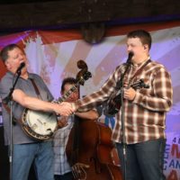 Steve Dilling congratulates Zack Arnold as he leaves Sideline to join Rhonda Vincent at the May 2021 Gettysburg Bluegrass Festival - photo by Frank Baker