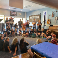 Students enjoy a bluegrass performance at the 2021 West Virginia State Folk Festival Youth Camp in Glenville, WV
