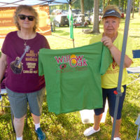 Lorraine and Debbie displaying the official festival t-shirt for the 2021 Willow Oak Bluegrass Festival - photo by Sandy Hatley