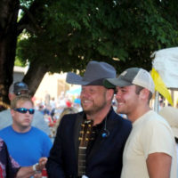 Jamie Dailey poses with a fan at the 50th annual Smithville Fiddlers Jamboree, July 2021