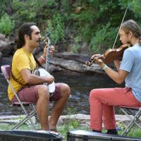 Ricky Mier (banjo contest winner) jams with Jackson Earles (second place fiddle winner) at RockyGrass 2021 - photo by Kevin Slick