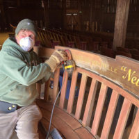 Sanding away at the Charles Sawtelle Memorial Bench during restoration