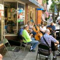 Locals pick outside Barr's Fiddle Shop during the 2021 Old Fiddlers Convention - photo by Eric Alfredson
