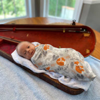 Cole McAvinue resting comfortably in his dad's old fiddle case