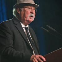 Dudley Connell introduces Lee Michael Demsey at the IBMA Industry Awards - photo © Bill Reaves