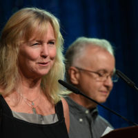 Wendy Tyner and Fred Bartenstein introduce Nancy Cardwell Webster at the 2021 IBMA Industry Awards - photo © Bill Reaves