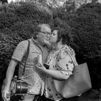 Lou Reid and Kattie Dills quickly smooch before the show begins. The Seldom Scene performed to a crowd of 1200 at Mount Airy Farm, Warsaw, VA Saturday September 25th, 2021 - photo by Jeromie Stephens