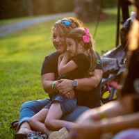 Starlette Boswell Johnson and her daughter watching Bobby Osborne from the front row, Sunday September 5th, 2021. Camp Springs, North Carolina - photo by Jeromie Stephens