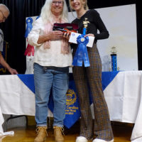 Vivian Pennington Hopkins presents first place fiddler, Grace Bemus, with John Ralph Pennington Memorial Award for the night's best fiddling at the 2021 Granite Quarry Fiddlers' Convention in Salisbury, NC - photo by Gary Hatley
