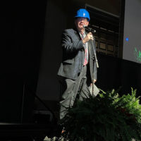 Hard hatted Joe Mullins welcomes everyone to the 2021 Industrial Strength Bluegrass Festival - photo by Kimberly Williams