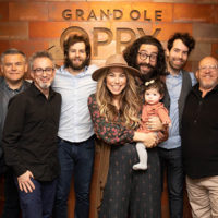 Nefesh Mountain backstage at The Opry (12/14/21): Dan Rogers/Vice President & Executive Producer, Grand Ole Opry; Alan Grubner, David Goldenberg, Doni Zasloff with baby Willow Lindberg, Eric Lindberg, Sam Weber and Neal Spielberg/Manager, Rockit Management - photo by Chris Hollo for the Opry