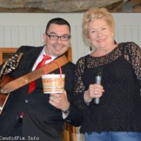 Corey Zink and his bucket of donuts with Sherry Boyd at the Spring 2022 Palatka Bluegrass Festival - photo © Bill Warren