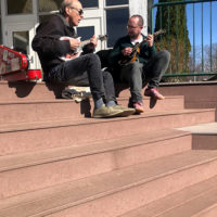 Don Stiernberg and Joe K Walsh sunning themselves on dining hall steps.  Photo Kelly Stockwell