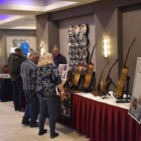 Guitar maker John Ressler displays his wares at the 2022 Naperville Bluegrass Festival