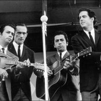 The Kentucky Colonels, onstage at the Newport Folk Festival, 1964.-L-R-Roland-White,-Bill-Ray-Latham,-Clarence-White,-Roger-Bush.-Photo-credit-Jim-Marshall.