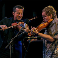 Jason Carter and Michael Cleveland with Del McCoury Band at DelFest 2022 - photo by Marc Shapiro Media